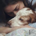Woman cuddles springer spaniel. The loss of your dog is heartbreaking. Take the time to honor your dog, grieve, and seek support as you cope with your loss.