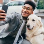 Man poses for selfie with his golden retriever. Adding dog pictures to a dating profile on Bumble provided 22% more matches and 30% more total interactions for women, while men with their dogs received 45% matches and 39% more total interactions.