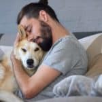 Man cuddles with German Shepherd. Securing an ESA Letter for Housing can be easy. Use this guide to complete the process in the most convenient and affordable way possible.