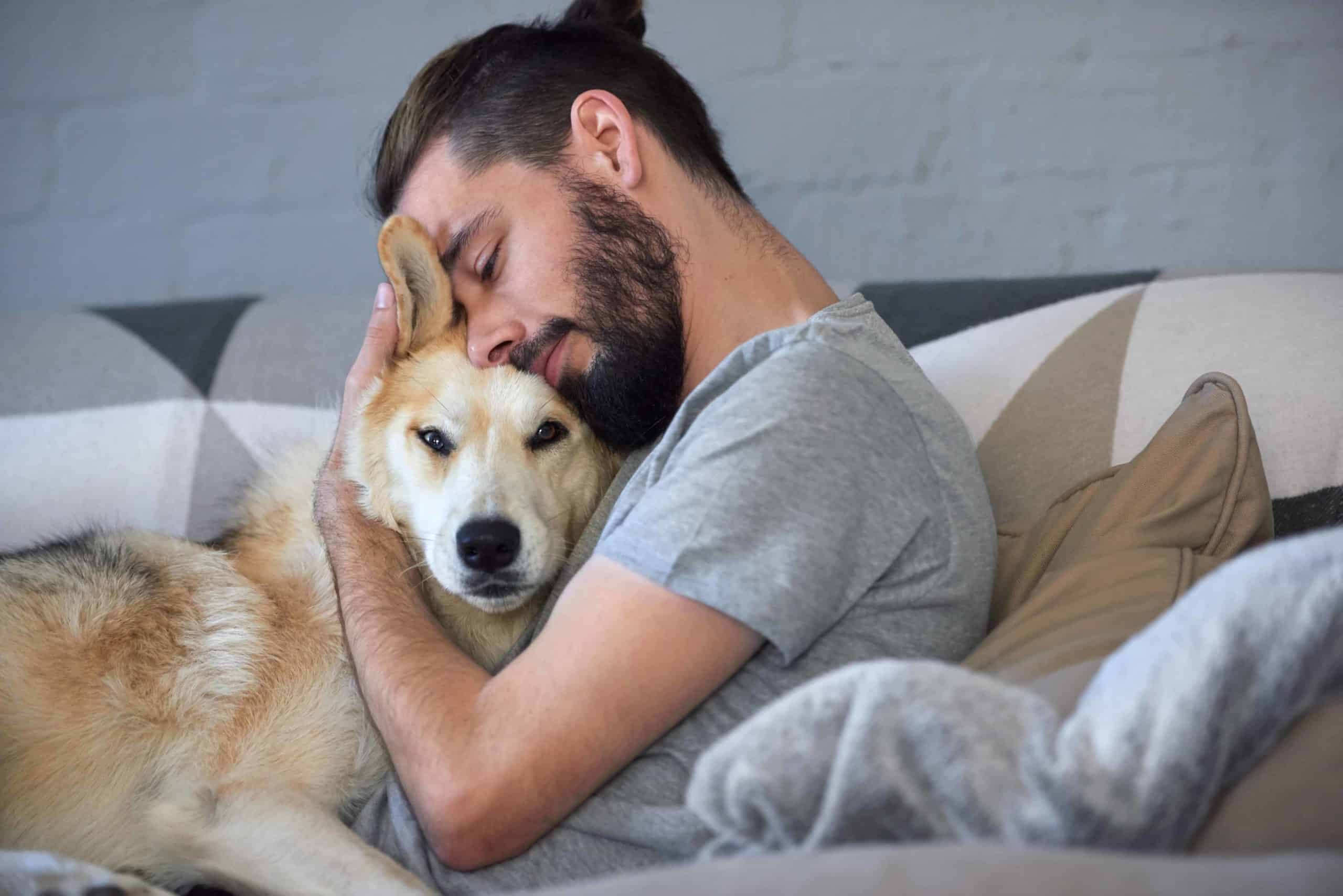 Man cuddles with German Shepherd. Securing an ESA Letter for Housing can be easy. Use this guide to complete the process in the most convenient and affordable way possible.