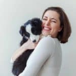 Woman cuddles Border Collie puppy. Adopting a pet can reduce stress. Securing an ESA pet letter for housing helps ensure you can live anywhere, even in housing that isn't pet-friendly.
